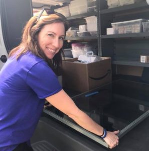 TRSA's Emily Mortimer unloads monitor from the STEM Shoppe